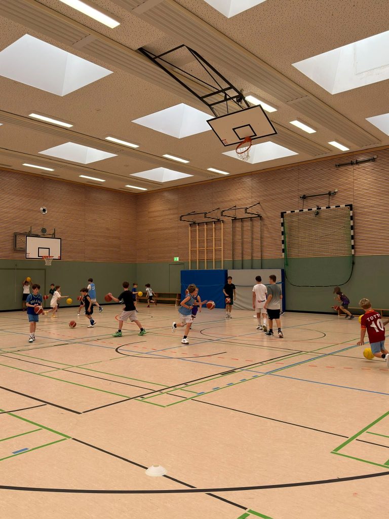 Kinder dribbeln durch die Halle